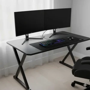 A gaming desk under £200 comfortably supporting two 24-inch monitors and a mechanical keyboard.