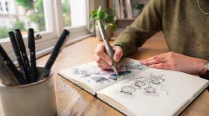 An illustrator holding an ergonomic illustration pen, highlighting comfort during long drawing sessions.