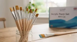 Selection of flat and round synthetic paint brushes included in a standard UK beginner acrylic painting kit.