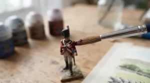 Detailed miniature painting using a fine-detail brush from an affordable art set.